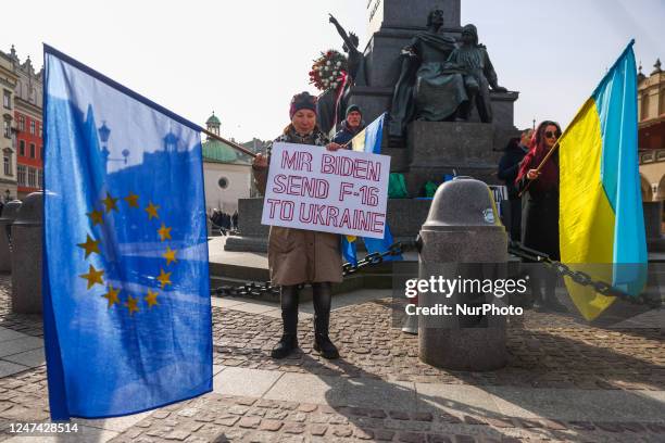 Ukrainian citizens and supporters attend a daily demonstration of solidarity with Ukraine at the Main Square one day ahead of one-year anniversary of...