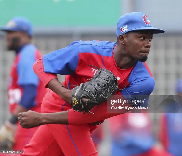 Livan Moinelo, who is on Cuba's World Baseball Classic team, pitches in a warm-up game against the SoftBank Hawks at Ivy Stadium in Miyazaki,...