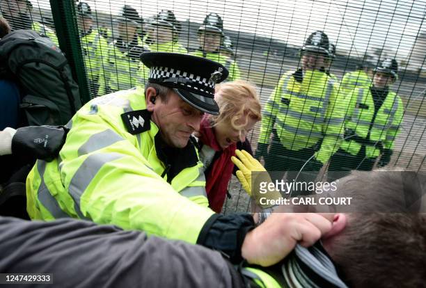 Police tackle protesters during a demonstration on October 2009 at the German energy giant E.ON 's Ratcliffe-on-Soar power station, near Nottingham,...