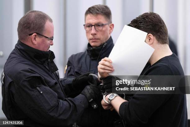 Judicial officers bring a defendant to the courtroom of the Higher Regional Court in Dresden, eastern Germany on February 24, 2023 prior to a hearing...