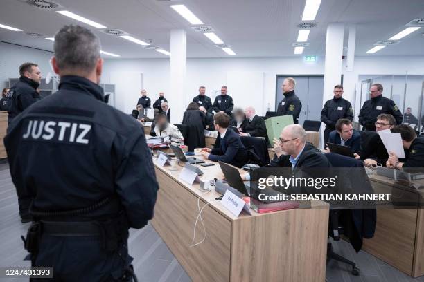 Defendant sit as they arrive at the Higher Regional Court in Dresden, eastern Germany on February 24, 2023 prior to a hearing in the trial over a...