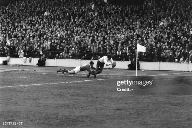 France's Jean Sillieres is tackled by Ireland Willie Duggan during the Five Nations rugby union match between France and Ireland in Colombes on...