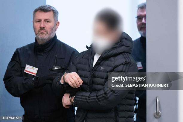 Judicial officers bring a defendant to the courtroom of the Higher Regional Court in Dresden, eastern Germany on February 24, 2023 prior to a hearing...