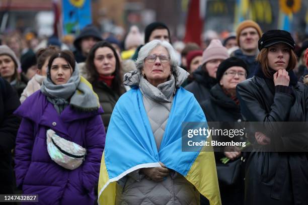 Demonstrator closes her eyes during an event to mark one year since the Russian invasion into Ukraine, in Riga, Latvia, on Friday, Feb. 24, 2023....