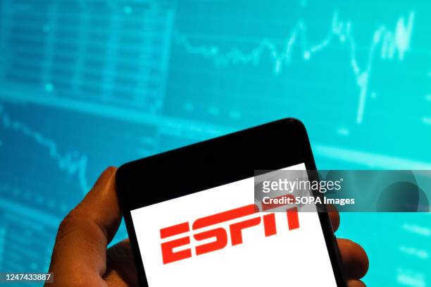 In this photo illustration, the American sports media conglomerate majority-owned by The Walt Disney Company, ESPN, logo is seen displayed on a...
