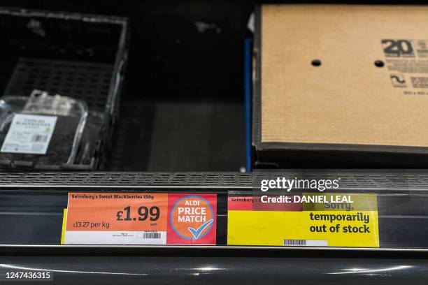 Photograph taken on February 24 shows empty shelves at a Sainsbury supermarket in east London with a message warning about the delivery problem...