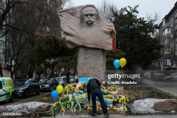 Kazakh people lay flowers at the monument to Taras Shevchenko in honor of the anniversary of the war between Russia and Ukraine in Almaty, Kazakhstan...