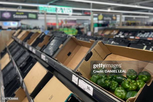 Photograph taken on February 24 shows a few peppers among empty shelves at a Sainsbury supermarket in east London. - Some UK supermarkets have...