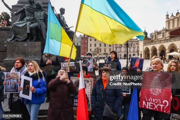 Ukrainian citizens and supporters attend a demonstration of solidarity with Ukraine at the Main Square, commemorating one-year anniversary of Russian...