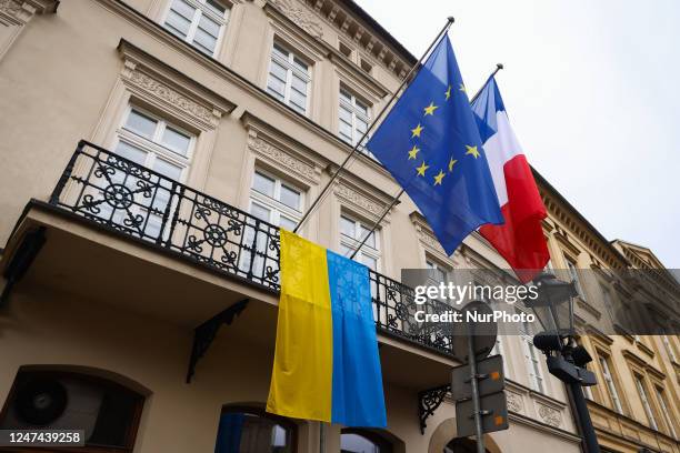 Ukrainian flag is seen hanging next to French and EU flags at Consulate General of the Republic of France, commemorating one-year anniversary of...