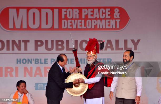 India Prime Minister Narendra Modi is presented with Naga traditional attires by Nagaland State Chief Minister Neiphiu Rio during a public rally...