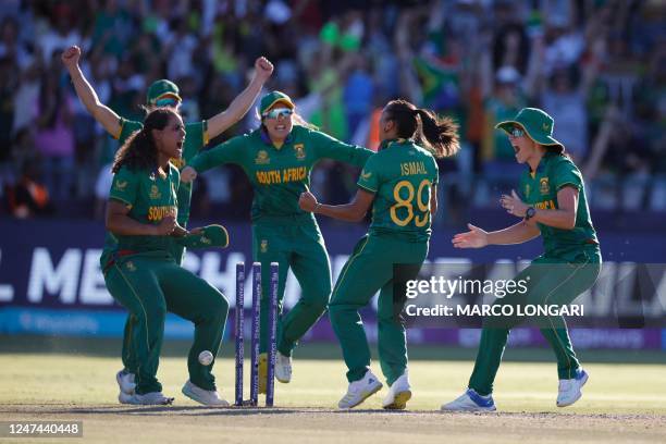 South African players celebrate winning the semi-final T20 women's World Cup cricket match between South Africa and England at Newlands Stadium in...