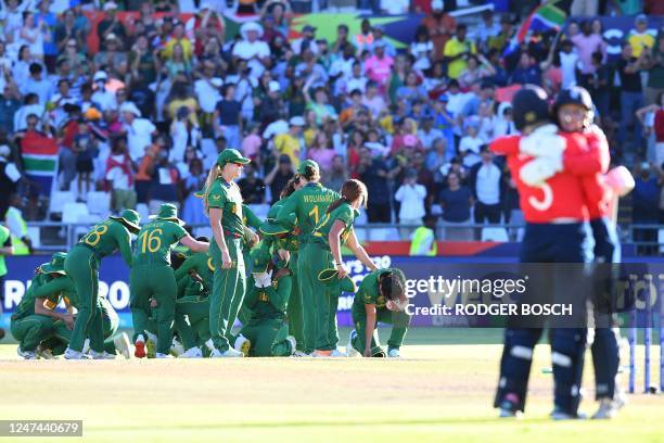 South African players celebrate winning the semi-final T20 women's World Cup cricket match between South Africa and England at Newlands Stadium in...