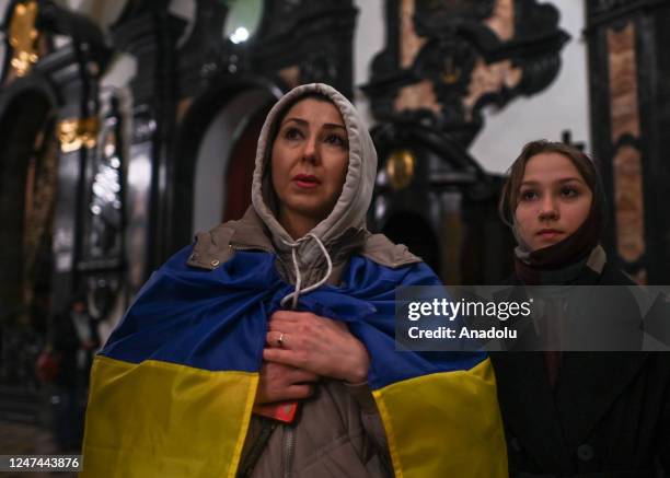 Ukrainians are seen during a Holy Mass in Wawel Cathedral ahead of the symbolic march 'Together for Peace' that will take place in streets of Krakow...