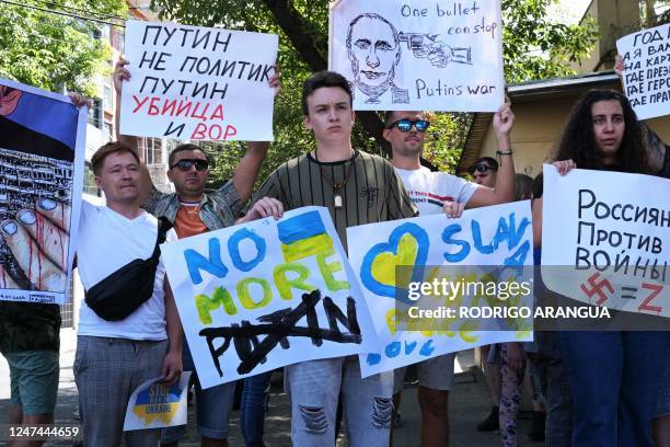 Russian citizens take part in a protest against the war and Russian President Vladimir Putin, in front of the Russian embassy in Mexico City on...