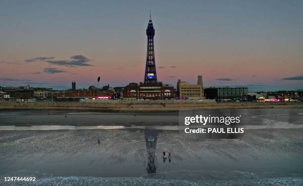 The Blackpool Tower is lit up in the colours of the national flag of Ukraine in Blackpool, north-west England, on February 24 on the first...