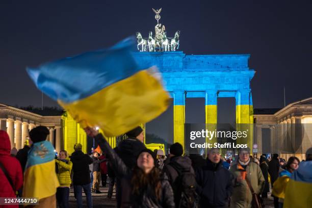 People, many of them expatriate Ukrainians living in Berlin, gather in front of the Brandenburg Gate to commemorate the first anniversary of Russia's...