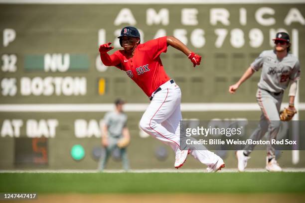 Rafael Devers of the Boston Red Sox steals third base during the first inning a Spring Training Grapefruit League game against the Northeastern...