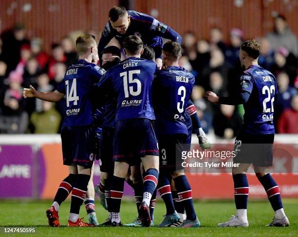 Dublin , Ireland - 24 February 2023; Joe Redmond of St Patrick's Athletick, hidden, celebrates with teammates after scoring his side's first goal...
