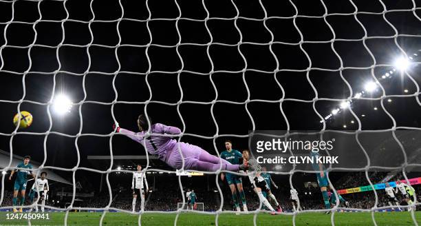 Fulham's Israeli striker Manor Solomon watches as his shot beats Wolverhampton Wanderers' Portuguese goalkeeper Jose Sa for their goal during the...