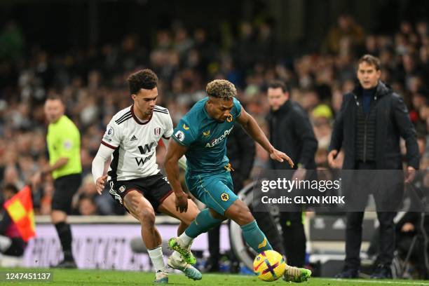 Fulham's English-born US defender Antonee Robinson vies with Wolverhampton Wanderers' Spanish midfielder Adama Traore during the English Premier...