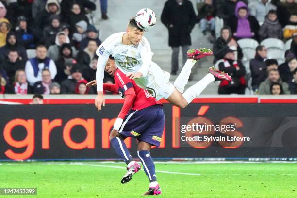 Jonathan David of Lille OSC is challenged by Achraf Dari of Stade Brestois during the Ligue 1 Uber Eats match between Lille and Brestois at Stade...