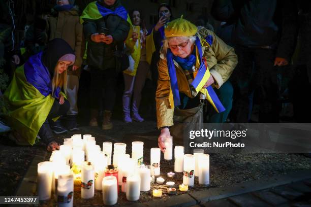 People light candles during the March for Victory to show solidarity with Ukraine and commemorate one year anniversary of Russian invasion on...