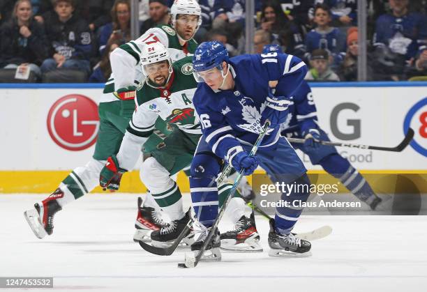 Matt Dumba of the Minnesota Wild tries to contain Mitchell Marner of the Toronto Maple Leafs during an NHL game at Scotiabank Arena on February 24,...