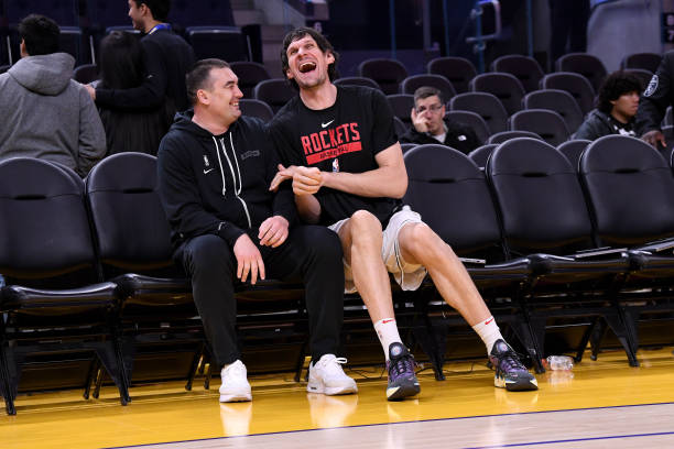 Golden State Warriors Assistant Coach Dejan Milojevic and Boban Marjanovic of the Houston Rockets smile on the sideline during the game between the...