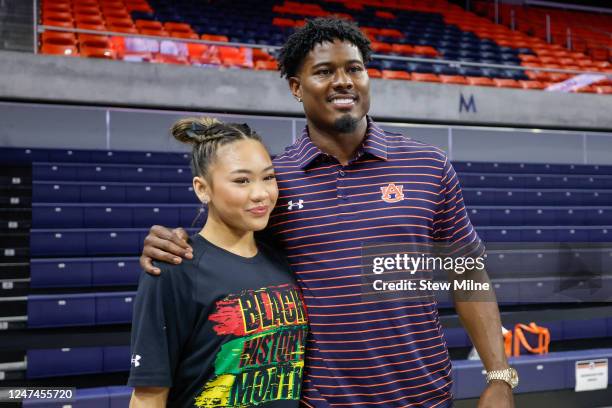 Sunisa Lee of Auburn poses for a photo with Jonathan Jones of the New England Patriots at Neville Arena on February 24, 2023 in Auburn, Alabama.