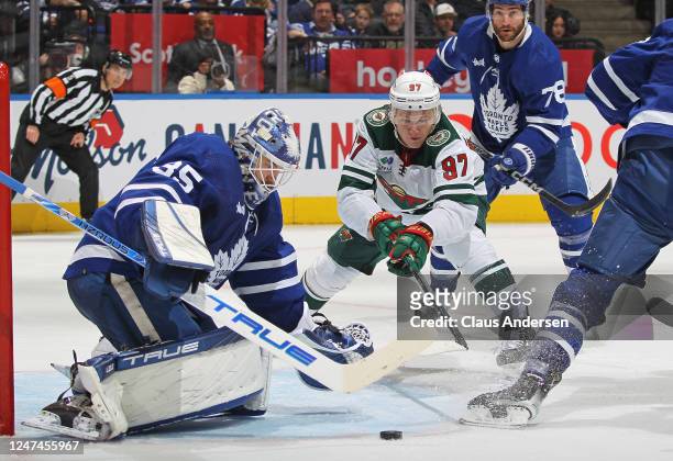 Kirill Kaprizov of the Minnesota Wild reaches for a puck against Ilya Samsonov of the Toronto Maple Leafs during an NHL game at Scotiabank Arena on...