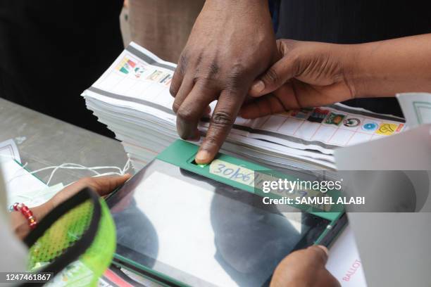 Voter's indentity is confirmed by fingerprint on a Bimodal Voter Accreditation System at a polling station in Ibadan on February 25 during Nigeria's...