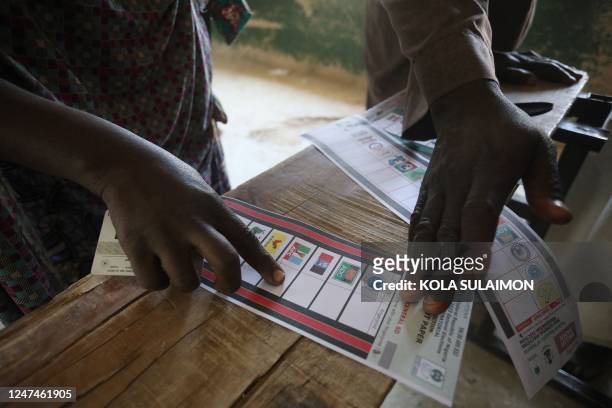 Voter points on a ballot paper at a polling station at Kwankwaso ward, Malamai in Kano on February 25 during Nigeria's presidential and general...