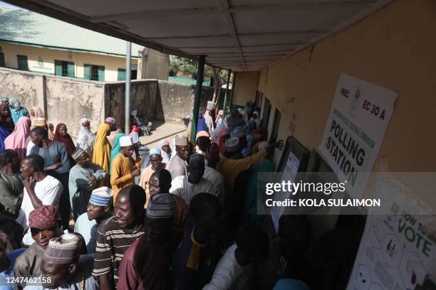 Voters queue to cast their ballots at a polling station at Kwankwaso ward, Malamai in Kano on February 25 during Nigeria's presidential and general...