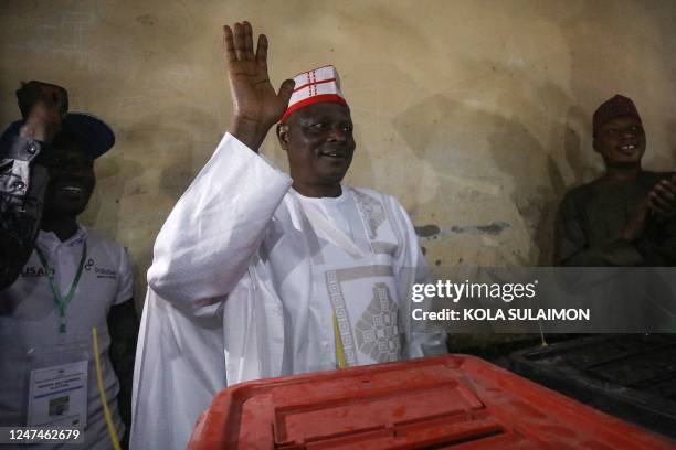 New Nigerian People Party presidential candidate Rabiu Kwankwaso waves after casting a ballot at a polling station in Kano on February 25 during...