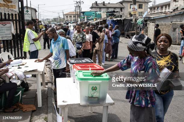 Woman casts her ballot at a polling station in Lagos on February 25 during Nigeria's presidential and general election.