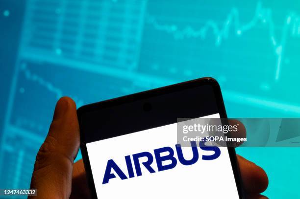 In this photo illustration, the European aerospace multinational and airplane manufacturer Airbus logo is seen displayed on a smartphone with an...
