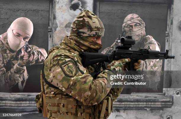 An officer of the Federal Security Service eximines a Kalashnikov AK-74 assault rifle on during the patriotic military event called "Be healthy is...