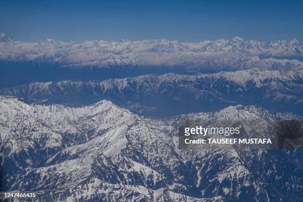 This aerial photo shows the snow covered mountains pictured from an aircraft flying over Srinagar on February 25, 2023.