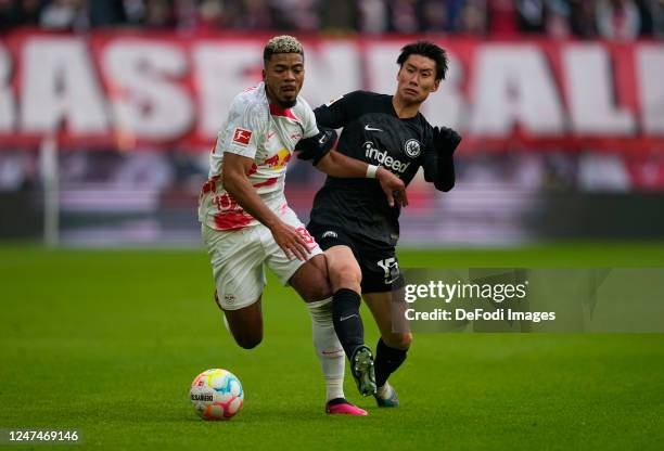 Benjamin Henrichs of RB Leipzig and Daichi Kamada of Eintracht Frankfurt battle for the ball during the Bundesliga match between RB Leipzig and...