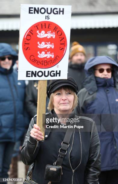 Protester holds a sign saying Enough is Enough- Stop the Boats as protesters gather at the railway station on February 25, 2023 in Skegness, England....