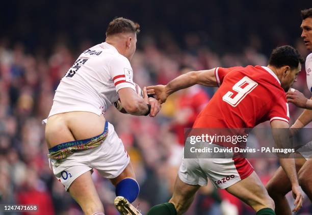 England's Freddie Steward loses his boxers and shorts as he runs with the ball during the Guinness Six Nations match at the Principality Stadium,...