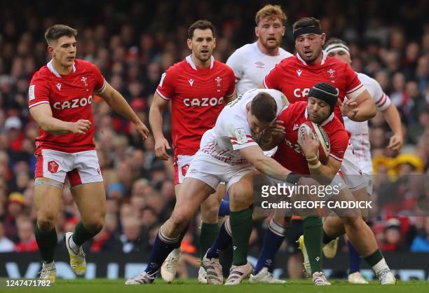 England's full-back Freddie Steward tackles Wales' full-back Leigh Halfpenny during the Six Nations international rugby union match between Wales and...