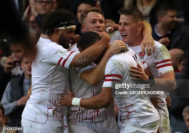 England's wing Anthony Watson celebrates after scoring the team's first try during the Six Nations international rugby union match between Wales and...