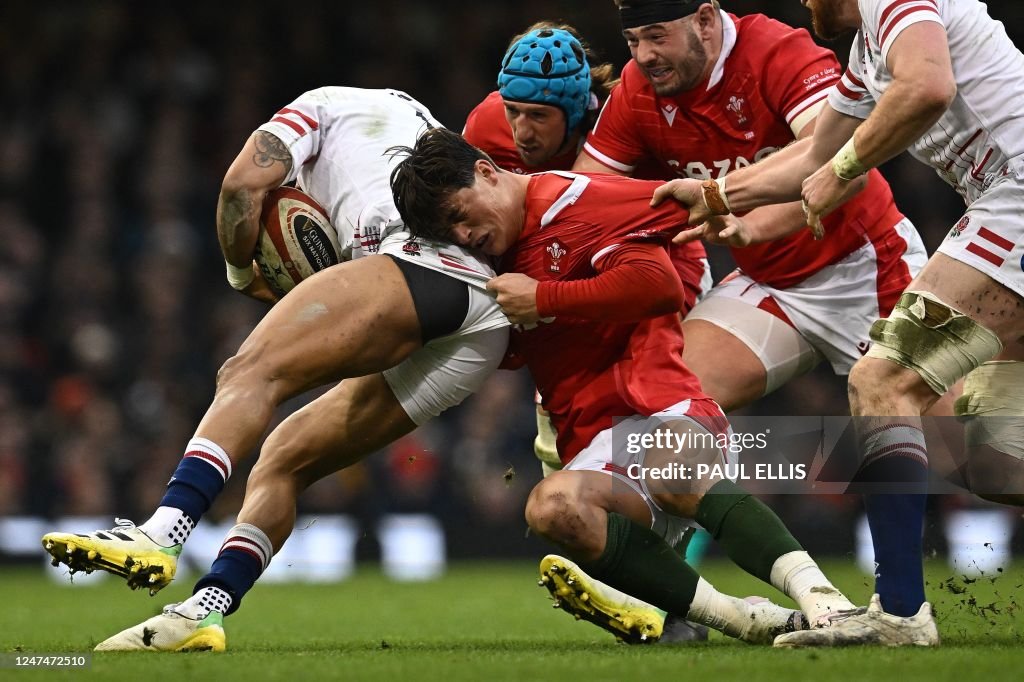 Wing In Rugby Wales' wing Louis Rees-Zammit pulls on the shorts of England's wing ...