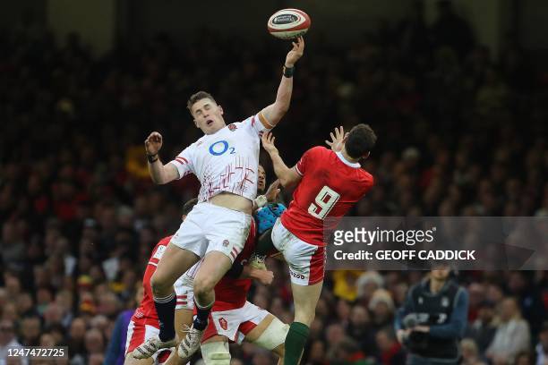 England's full-back Freddie Steward jumps above Wales' scrum-half Tomos Williams during the Six Nations international rugby union match between Wales...