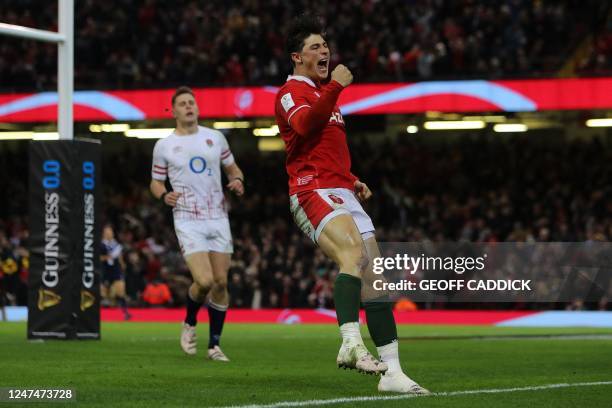 Wales' wing Louis Rees-Zammit celebrates after scoring the team's first try during the Six Nations international rugby union match between Wales and...