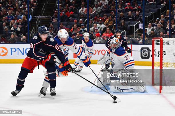 Jack Campbell of the Edmonton Oilers defends the net as Eric Robinson of the Columbus Blue Jackets and Tyson Barrie of the Edmonton Oilers battle for...