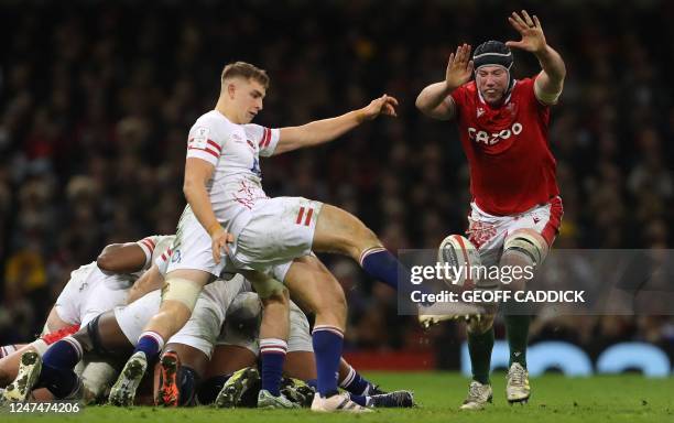 Wales' lock Adam Beard charges down a kick from England's scrum-half Jack van Poortlviet during the Six Nations international rugby union match...