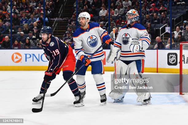 Jack Campbell of the Edmonton Oilers defends the net as Liam Foudy of the Columbus Blue Jackets and Evan Bouchard of the Edmonton Oilers battle for...